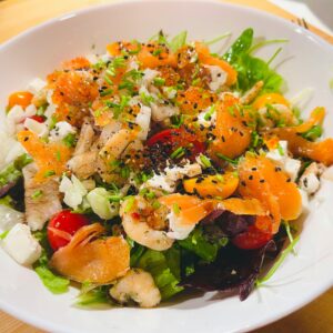 Colorful seafood salad with smoked salmon, prawns, and fresh vegetables perfect for a nutritious meal.